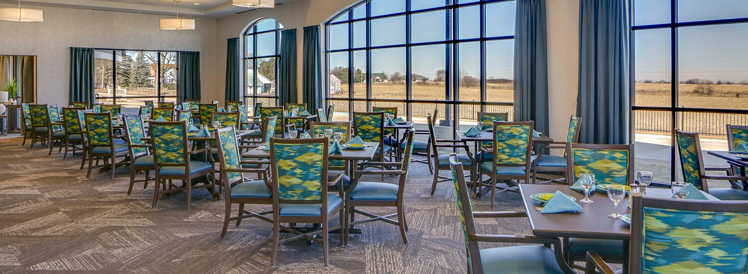 dining room with large windows and sets of tables and chairs