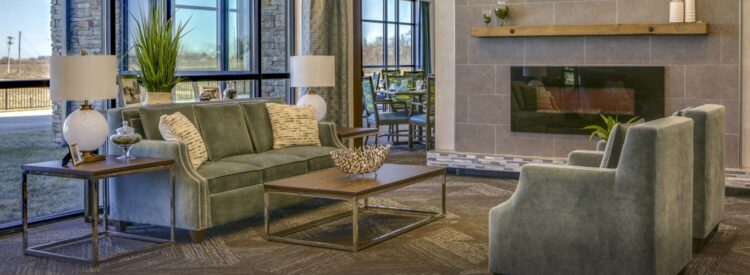 seating area in front of windows and fireplace