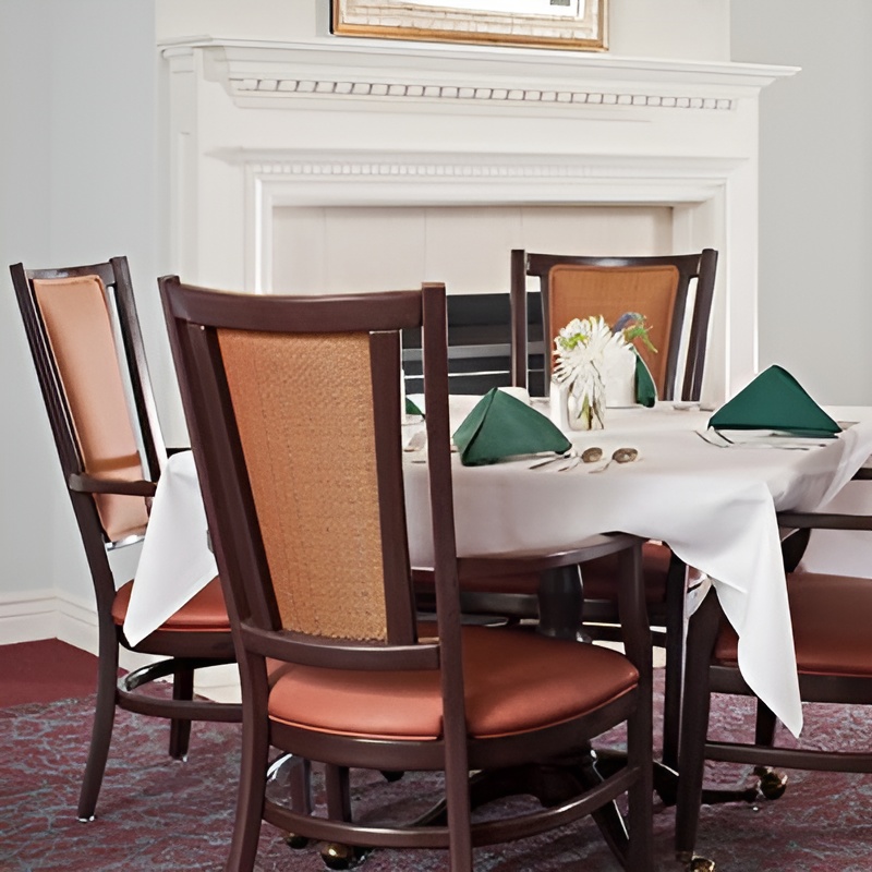 white clothed dining table in front of fireplace
