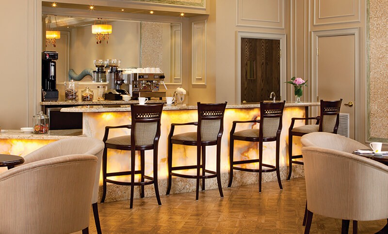 row of chairs along a yellow illuminated bar